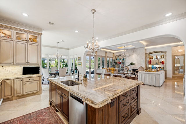 kitchen with stainless steel dishwasher, light stone countertops, sink, and a center island with sink