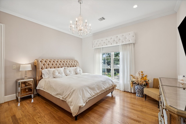 bedroom with an inviting chandelier, crown molding, and light hardwood / wood-style floors