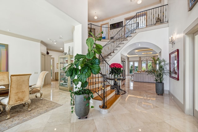 foyer featuring ornamental molding