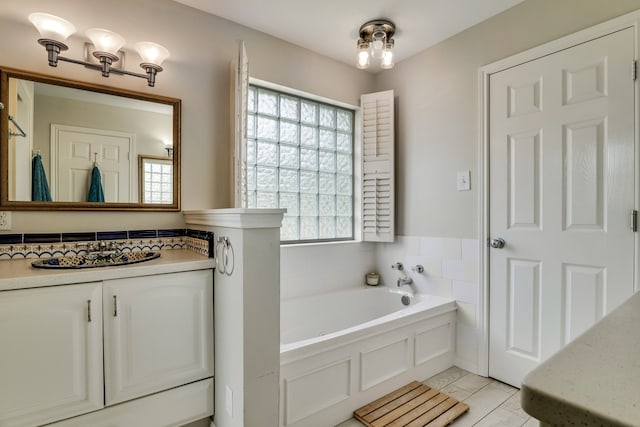 bathroom with tile patterned floors and a tub to relax in