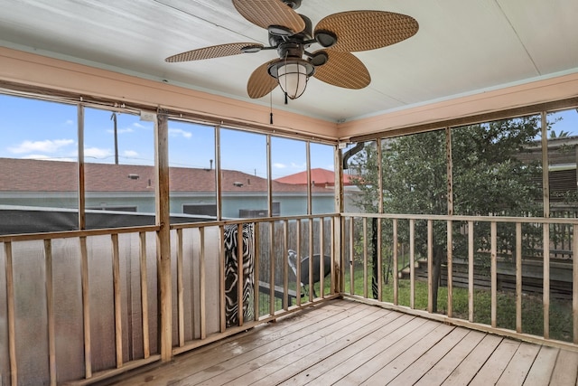 unfurnished sunroom with ceiling fan