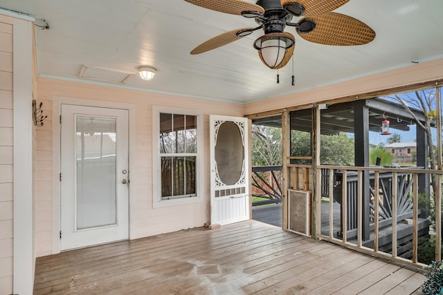 unfurnished sunroom featuring ceiling fan