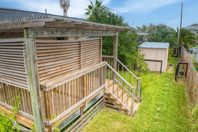 deck with a storage shed and a yard