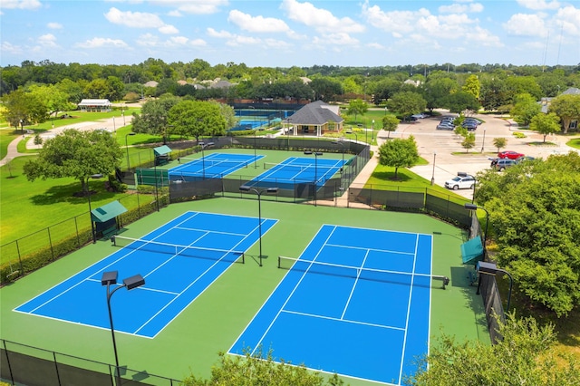 view of tennis court featuring fence