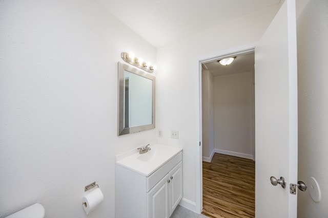 bathroom featuring vanity, toilet, and wood-type flooring