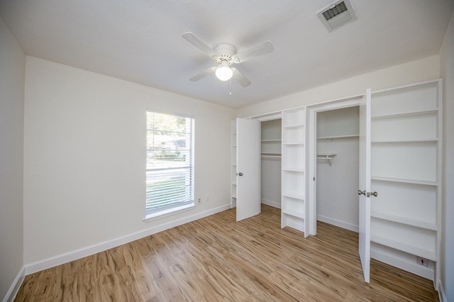 unfurnished bedroom with ceiling fan and light hardwood / wood-style floors