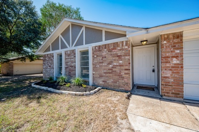 doorway to property with a garage