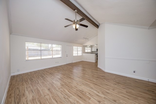 unfurnished living room featuring ornamental molding, lofted ceiling with beams, light hardwood / wood-style flooring, and ceiling fan