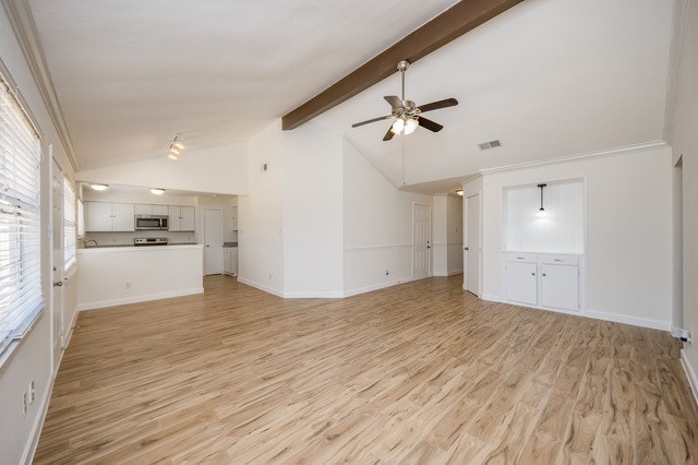 unfurnished living room featuring ceiling fan, lofted ceiling with beams, ornamental molding, and light wood-type flooring