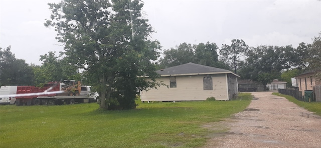 view of side of home featuring a lawn