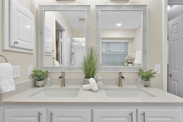 bathroom featuring vanity and an enclosed shower