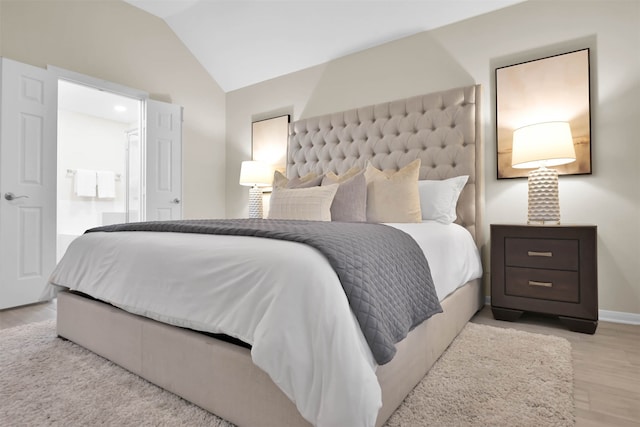 bedroom featuring light hardwood / wood-style floors and vaulted ceiling