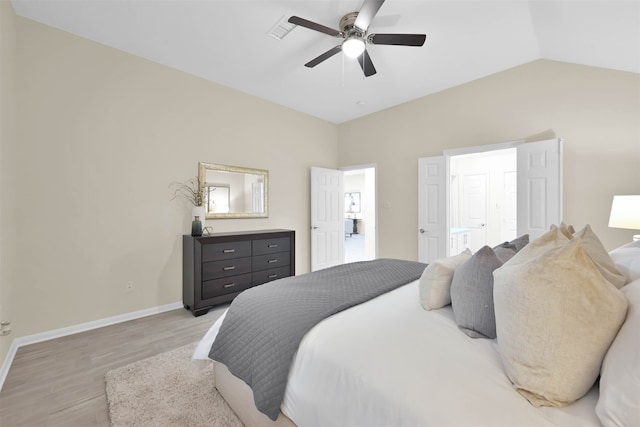 bedroom featuring ceiling fan, hardwood / wood-style flooring, and vaulted ceiling