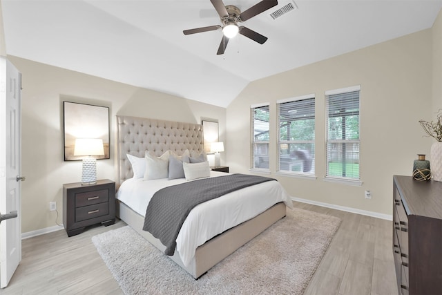 bedroom featuring light hardwood / wood-style flooring, ceiling fan, and vaulted ceiling