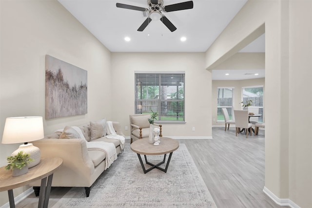 living room with light hardwood / wood-style floors and ceiling fan