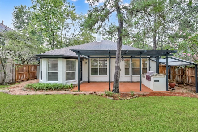 back of house with a yard and a patio area