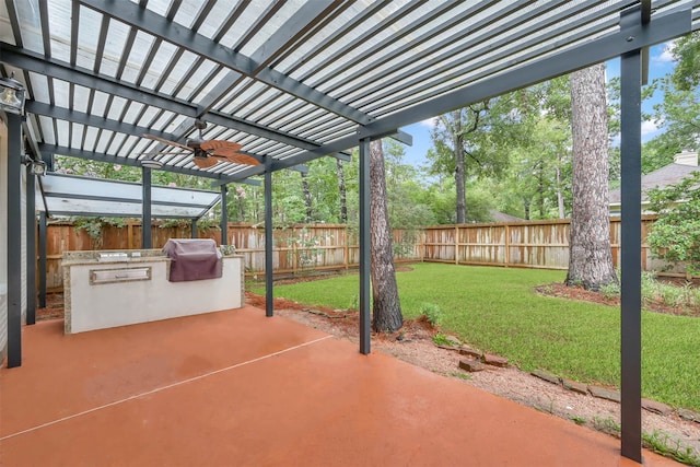 view of patio with a pergola, ceiling fan, a grill, and exterior kitchen