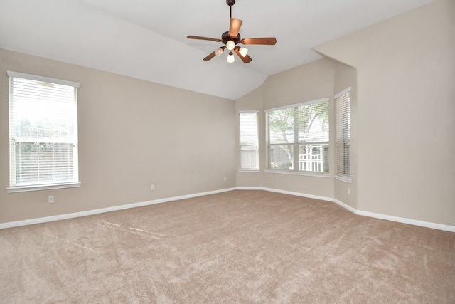 carpeted spare room with lofted ceiling and ceiling fan