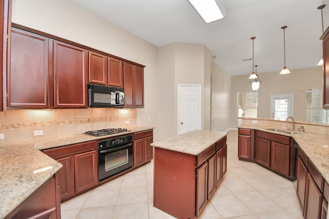 kitchen with hanging light fixtures, light tile patterned floors, light stone countertops, black appliances, and sink