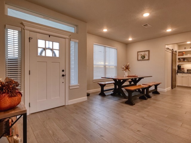 entrance foyer featuring light hardwood / wood-style flooring and a barn door