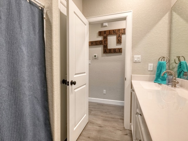 bathroom featuring vanity, wood-type flooring, and a shower with shower curtain