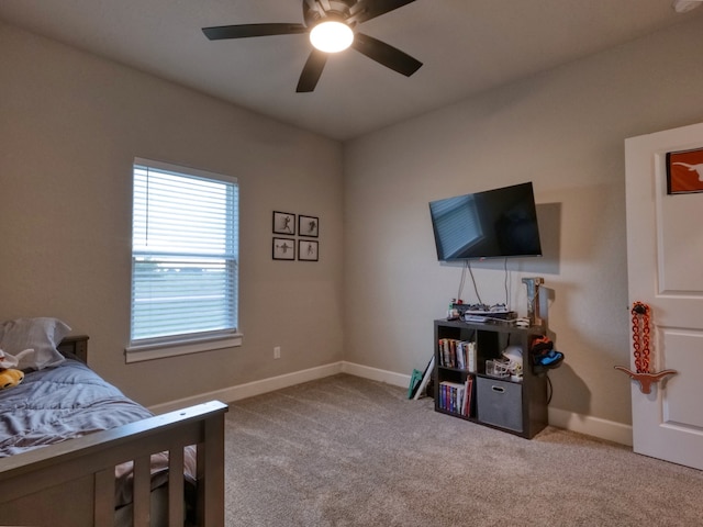 bedroom featuring ceiling fan and light carpet