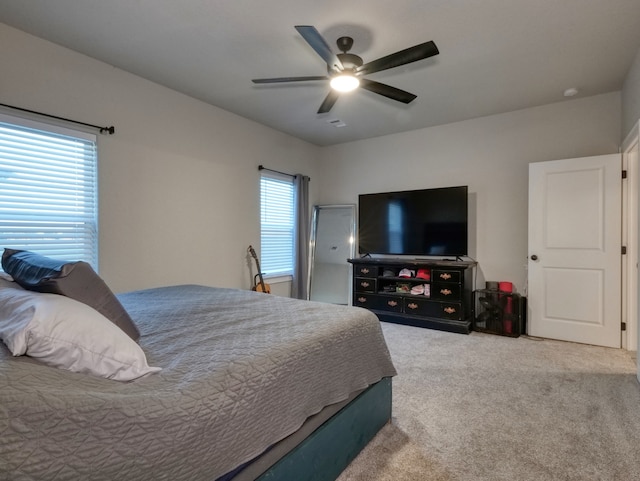 carpeted bedroom with ceiling fan