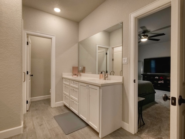 bathroom with vanity, wood-type flooring, and ceiling fan