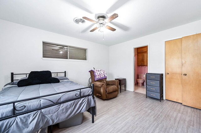 bedroom with ceiling fan, light wood-type flooring, and ensuite bath