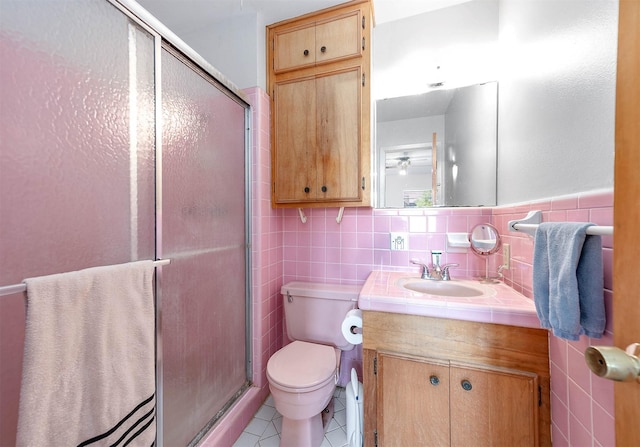 bathroom featuring tile walls, vanity, and tile patterned flooring