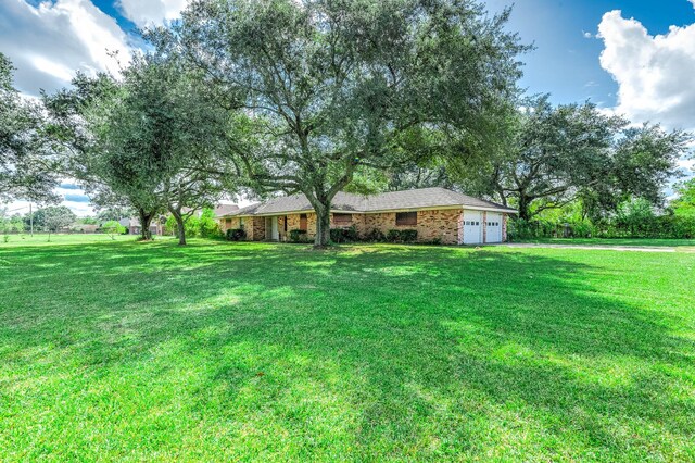 view of front of home featuring a garage and a front lawn