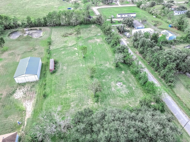 birds eye view of property with a rural view