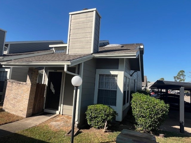 view of side of home featuring a carport