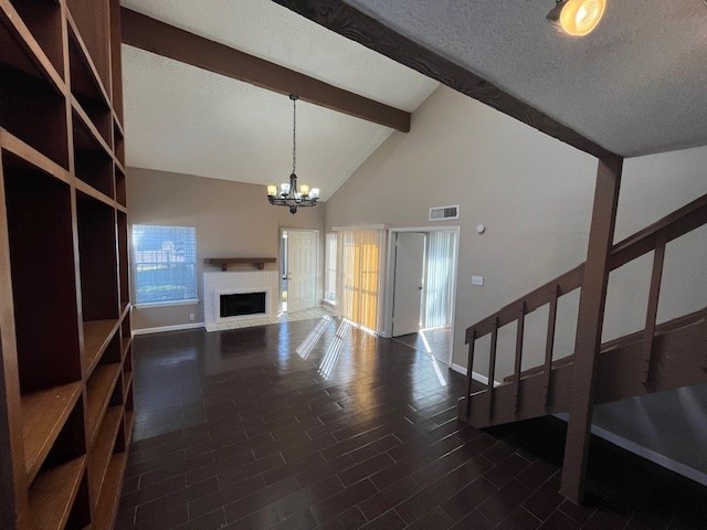 living room featuring a notable chandelier, beam ceiling, a healthy amount of sunlight, and high vaulted ceiling