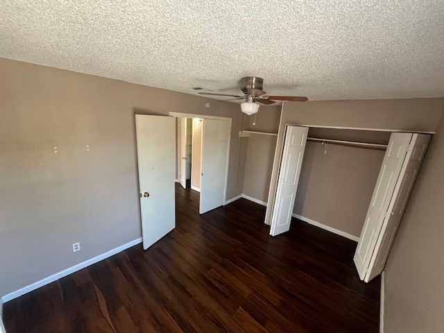 unfurnished bedroom with a closet, a textured ceiling, ceiling fan, and dark hardwood / wood-style flooring