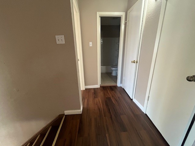 hallway with dark wood-type flooring