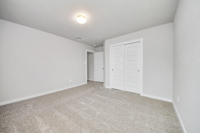 unfurnished bedroom with a closet and carpet flooring