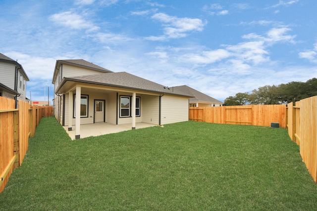 rear view of house with a patio and a lawn