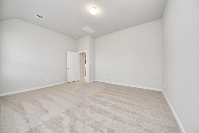 empty room with lofted ceiling and light colored carpet