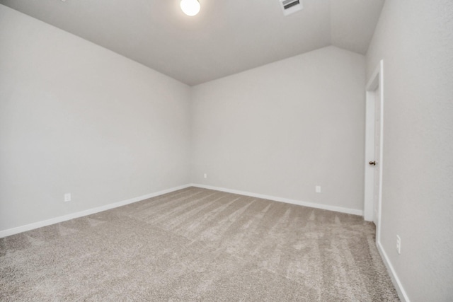 unfurnished room featuring carpet floors and lofted ceiling