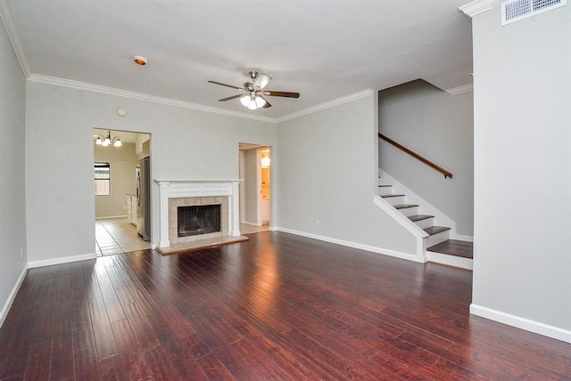 unfurnished living room featuring crown molding, a tiled fireplace, and wood-type flooring