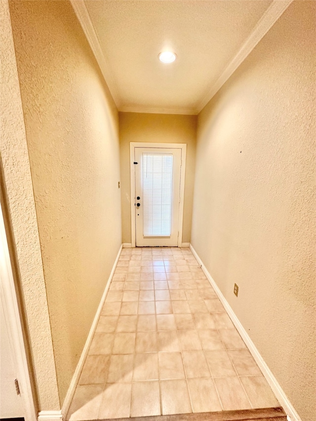 doorway with ornamental molding and light tile patterned floors