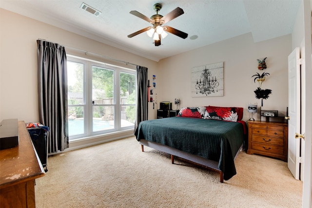 carpeted bedroom featuring visible vents and a ceiling fan