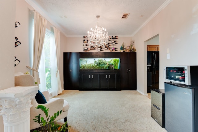 living area with a chandelier, visible vents, ornamental molding, and light colored carpet