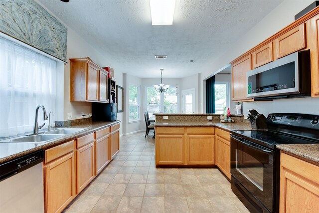 kitchen with stainless steel microwave, black electric range, a sink, a peninsula, and dishwashing machine