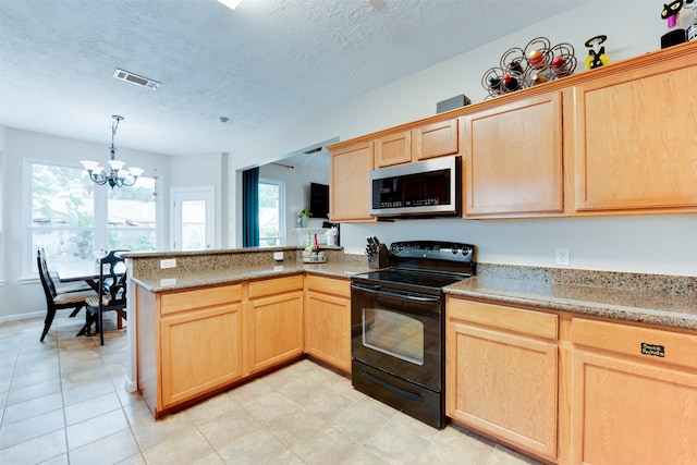 kitchen with stainless steel microwave, light brown cabinetry, black electric range, visible vents, and a peninsula