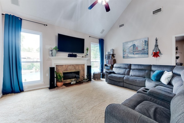 living area with carpet flooring, a ceiling fan, visible vents, and a fireplace