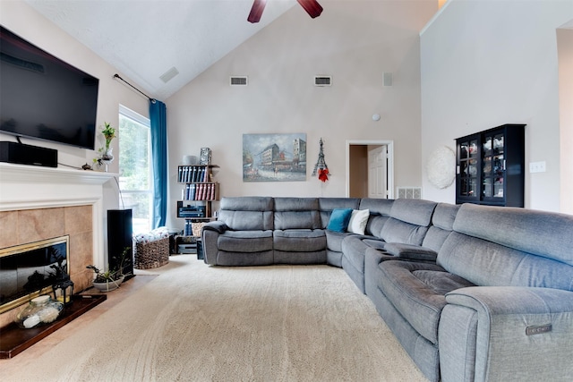 living room featuring carpet flooring, visible vents, a fireplace, a ceiling fan, and high vaulted ceiling