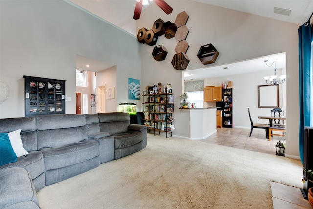living area with light tile patterned floors, baseboards, light carpet, high vaulted ceiling, and ceiling fan with notable chandelier