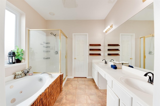 full bath featuring a stall shower, a whirlpool tub, and a sink